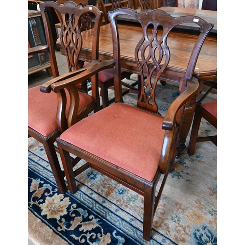 73 - A set of eight Chippendale style mahogany dining chairs with terracotta fabric pad seats, two carver... 