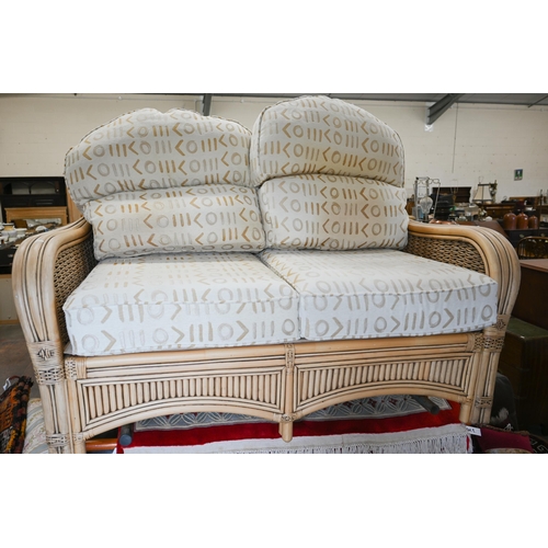 79 - A cane and wicker-rattan conservatory suite comprising a two-seater sofa, 150 cm x 80 cm x 100 cm h,... 