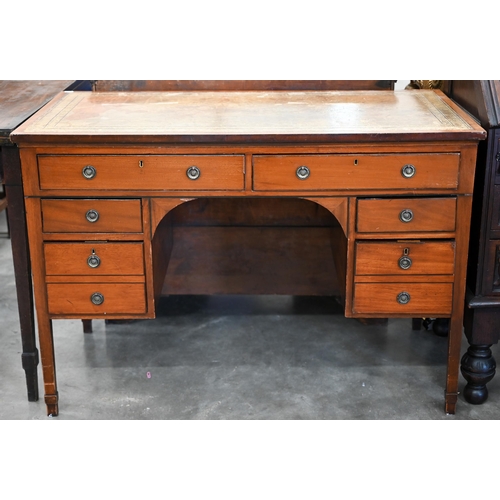 84 - An Edwardian mahogany kneehole desk with gilt tooled leather top and six drawers raised on square su... 