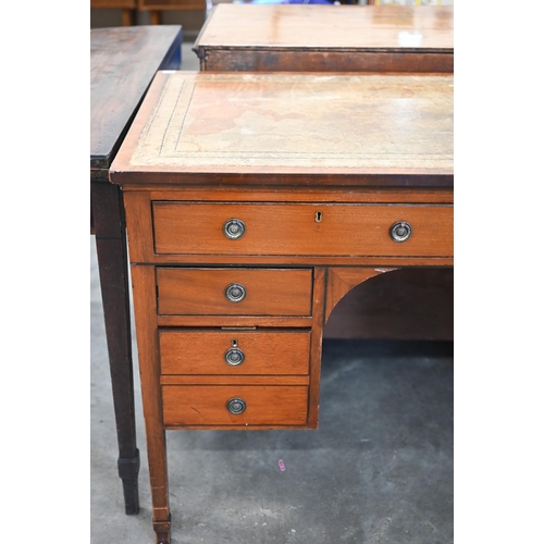 84 - An Edwardian mahogany kneehole desk with gilt tooled leather top and six drawers raised on square su... 