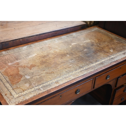 84 - An Edwardian mahogany kneehole desk with gilt tooled leather top and six drawers raised on square su... 