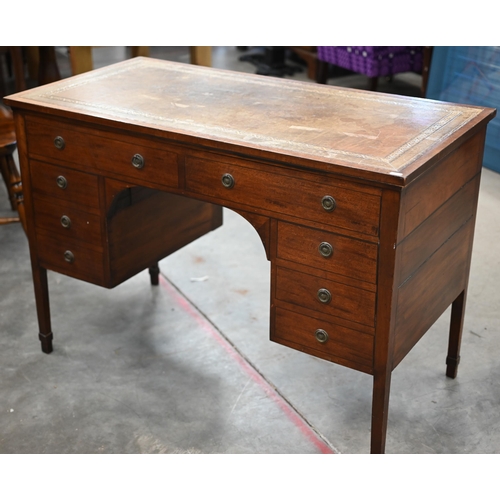 84 - An Edwardian mahogany kneehole desk with gilt tooled leather top and six drawers raised on square su... 