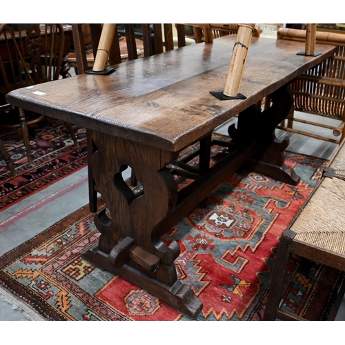 87 - A small elm refectory dining table on shaped trestle supports united by pegged mortice and tenon str... 