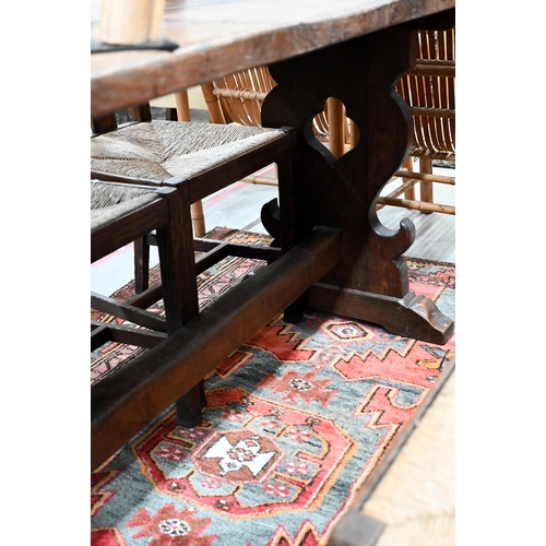 87 - A small elm refectory dining table on shaped trestle supports united by pegged mortice and tenon str... 