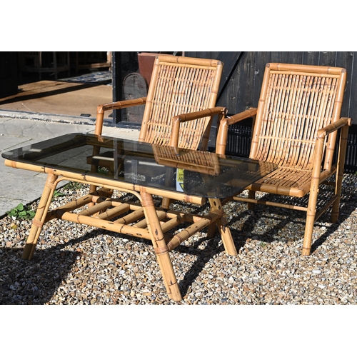 88 - A pair of vintage bamboo elbow chairs and coffee table with smoked glass top, 116 x 58 x 46 cm high