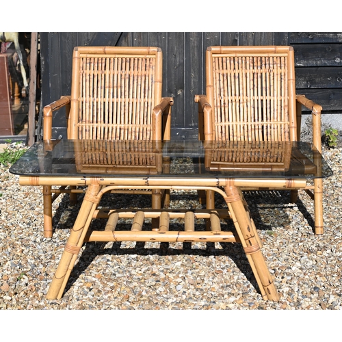 88 - A pair of vintage bamboo elbow chairs and coffee table with smoked glass top, 116 x 58 x 46 cm high