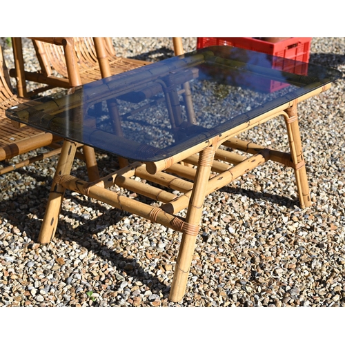 88 - A pair of vintage bamboo elbow chairs and coffee table with smoked glass top, 116 x 58 x 46 cm high