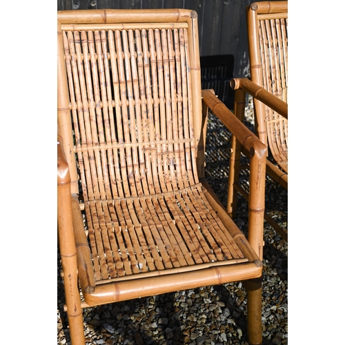 88 - A pair of vintage bamboo elbow chairs and coffee table with smoked glass top, 116 x 58 x 46 cm high