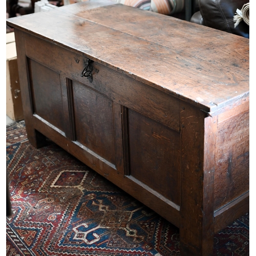 90 - A large antique oak and elm coffer of traditional panelled construction with hinge top, 134 x 60 x 6... 