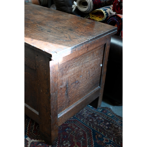 90 - A large antique oak and elm coffer of traditional panelled construction with hinge top, 134 x 60 x 6... 