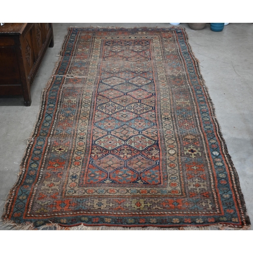 93 - Antique Kurdish runner of geometric design on red ground with repeating borders, very worn, 290 x 12... 