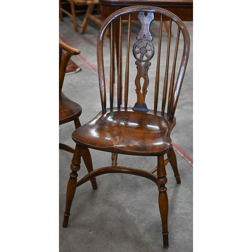 97 - An elm and ash wheelback Windsor chair with crinoline front stretcher to/w matching side chair (2)