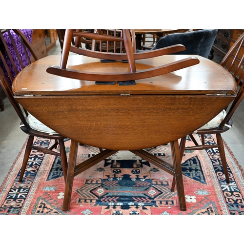 98 - An Ercol dark elm drop-leaf dining table, 110 cm x 124 cm x 70 cm h to/w four Windsor Quaker dining ... 