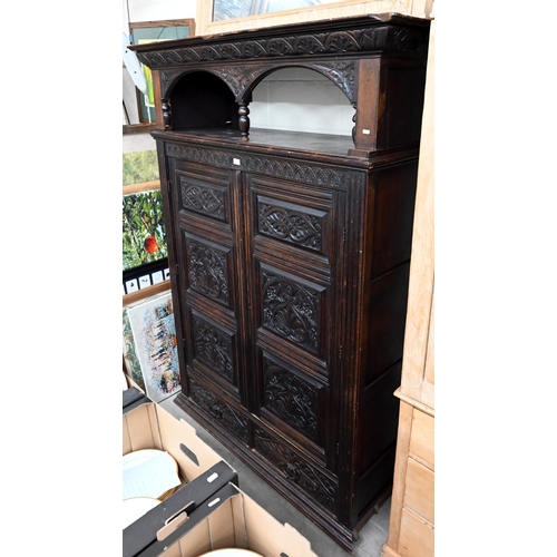 92 - # An antique carved oak hall cupboard with panelled doors over two drawers, a/f, 138 x 55 x 195 cm h... 