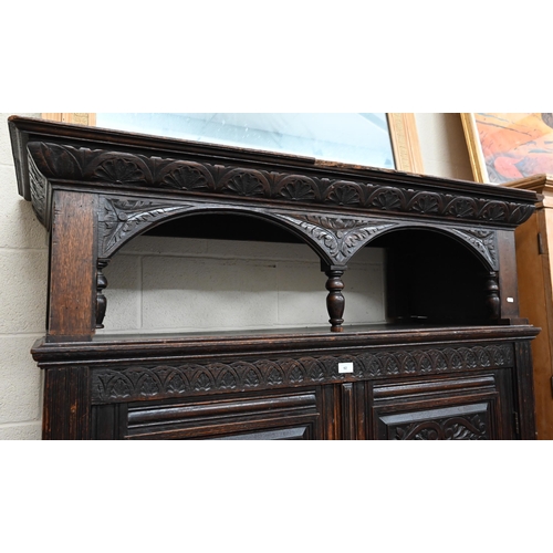 92 - # An antique carved oak hall cupboard with panelled doors over two drawers, a/f, 138 x 55 x 195 cm h... 