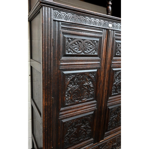 92 - # An antique carved oak hall cupboard with panelled doors over two drawers, a/f, 138 x 55 x 195 cm h... 