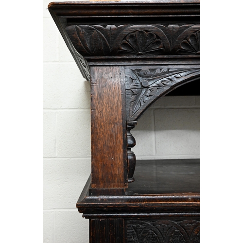 92 - # An antique carved oak hall cupboard with panelled doors over two drawers, a/f, 138 x 55 x 195 cm h... 