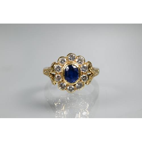 230 - A sapphire and diamond cluster ring, the oval collet set sapphire surrounded by ten brilliant cut di... 