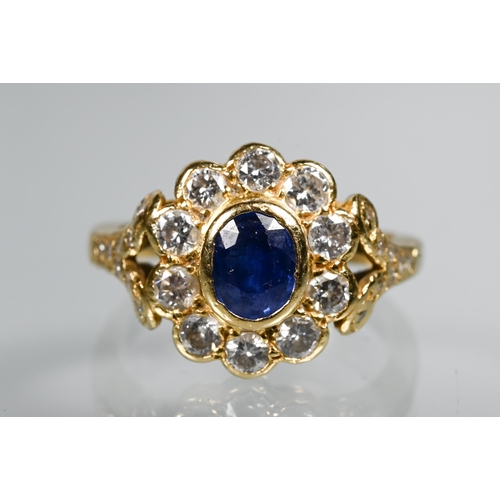 230 - A sapphire and diamond cluster ring, the oval collet set sapphire surrounded by ten brilliant cut di... 