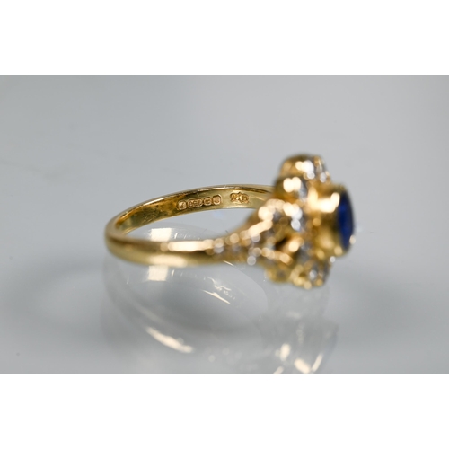 230 - A sapphire and diamond cluster ring, the oval collet set sapphire surrounded by ten brilliant cut di... 