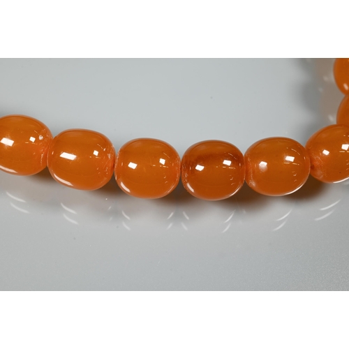 234 - Two rows of graduated amber beads, each with concealed screw clasp, approx 100g (2)