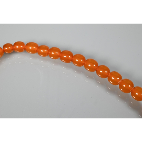 234 - Two rows of graduated amber beads, each with concealed screw clasp, approx 100g (2)