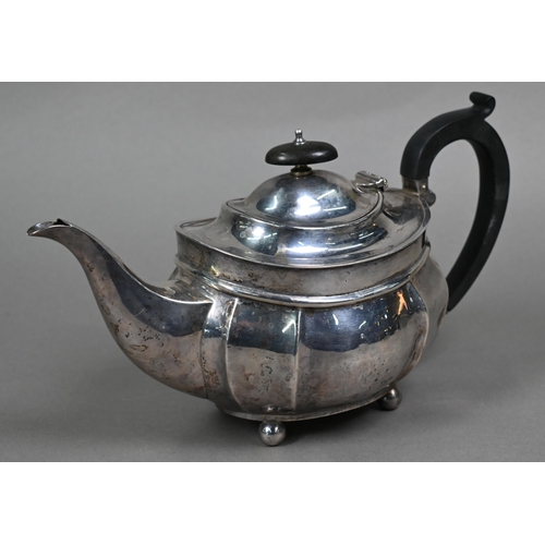113 - An oval silver teapot with composite handle and finial, on ball feet, Henry Williamson Ltd., Birming... 