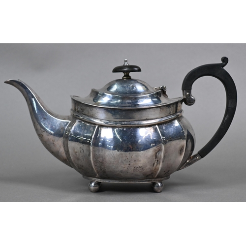 113 - An oval silver teapot with composite handle and finial, on ball feet, Henry Williamson Ltd., Birming... 