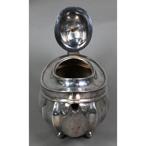 113 - An oval silver teapot with composite handle and finial, on ball feet, Henry Williamson Ltd., Birming... 
