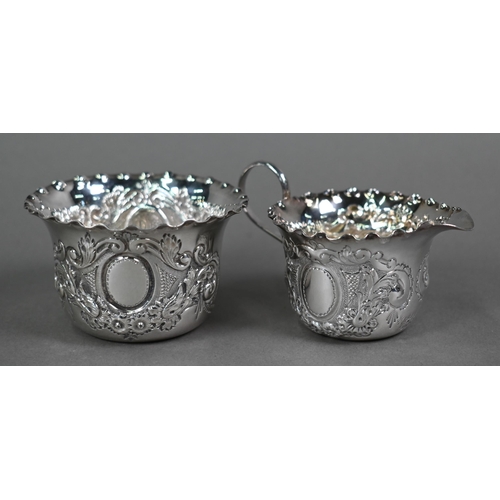 116 - A late Victorian cream and sugar pair with embossed and chased decoration, Josiah Williams & Co,... 