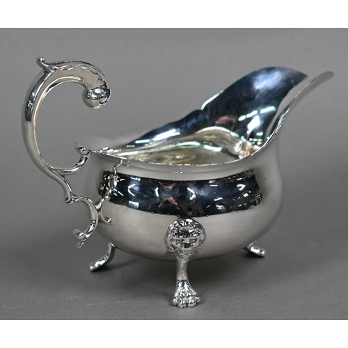 118 - An Edwardian silver pot-bellied sauce boat in the Georgian taste, with shaped rim and scroll handle,... 