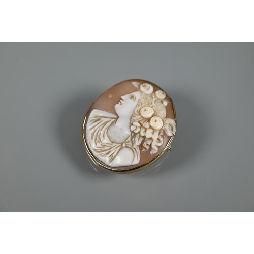 198 - An oval shell cameo brooch featuring female with elaborate hair, in 9ct yellow gold plain mount with... 