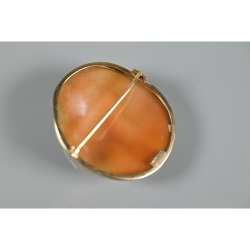 198 - An oval shell cameo brooch featuring female with elaborate hair, in 9ct yellow gold plain mount with... 