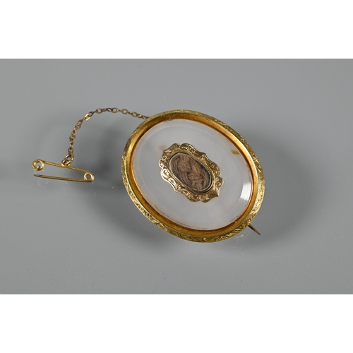 200 - A collection of mourning jewellery including oval chalcedony and hairwork brooch, coral and hairwork... 