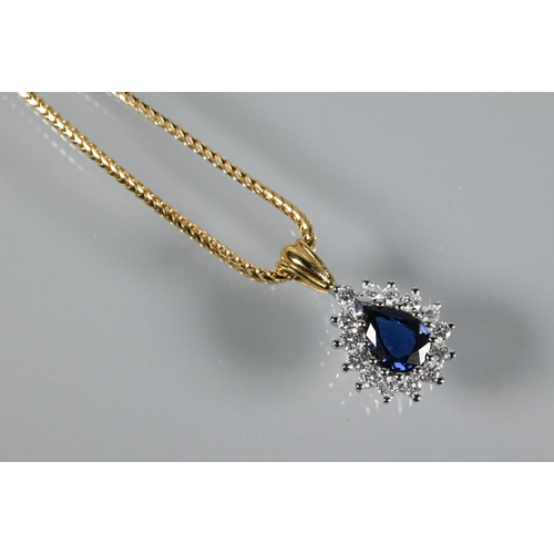 202 - A sapphire and diamond cluster pendant of tear-shaped form, 18ct yellow and white gold set, on 18ct ... 