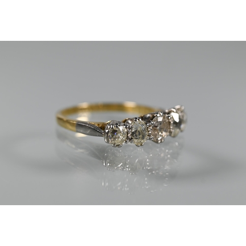 203 - A five stone diamond ring, the alternate oval and round diamonds in yellow and white metal setting s... 