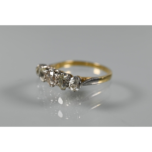 203 - A five stone diamond ring, the alternate oval and round diamonds in yellow and white metal setting s... 