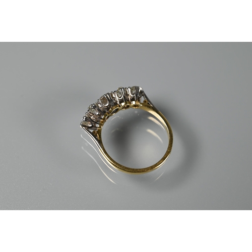 203 - A five stone diamond ring, the alternate oval and round diamonds in yellow and white metal setting s... 