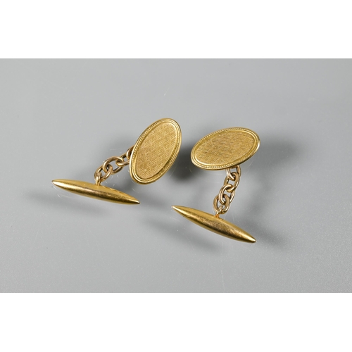 208 - A pair of 9ct yellow gold cufflinks with engine turned decoration and chain link torpedo backs, appr... 