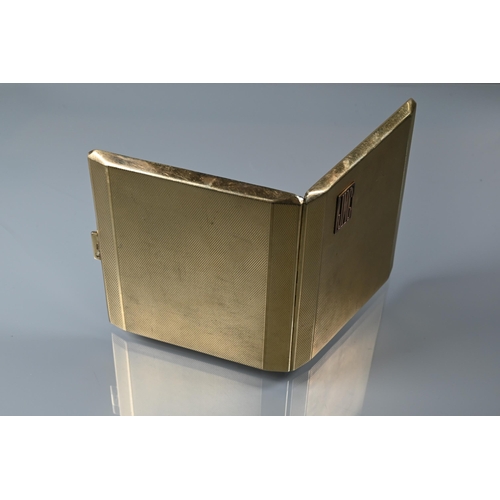 215 - A 9ct yellow gold cigarette case with engine turned decoration, applied monogram JMC and engraved wi... 