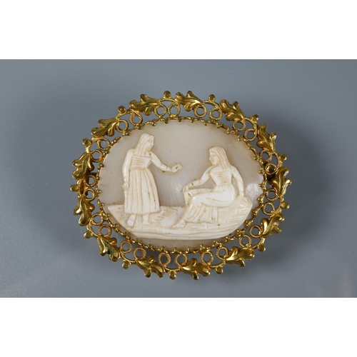 220 - A pale carved cameo shell brooch featuring two figures in decorative gilt metal surround to/w a carv... 