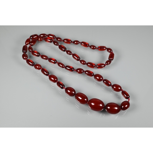 224 - A graduated cherry amber necklace, double knotted throughout, 54.7g