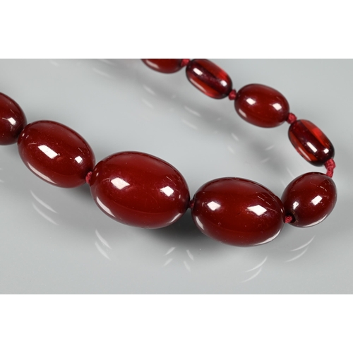 224 - A graduated cherry amber necklace, double knotted throughout, 54.7g