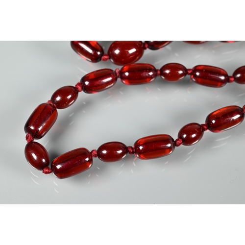 224 - A graduated cherry amber necklace, double knotted throughout, 54.7g