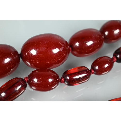 224 - A graduated cherry amber necklace, double knotted throughout, 54.7g