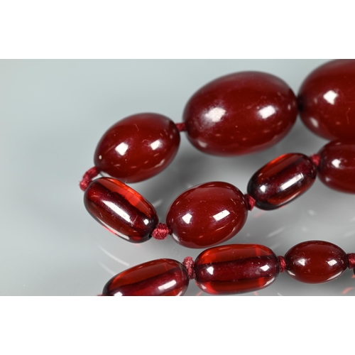 224 - A graduated cherry amber necklace, double knotted throughout, 54.7g