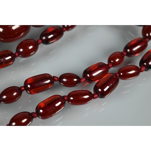 224 - A graduated cherry amber necklace, double knotted throughout, 54.7g