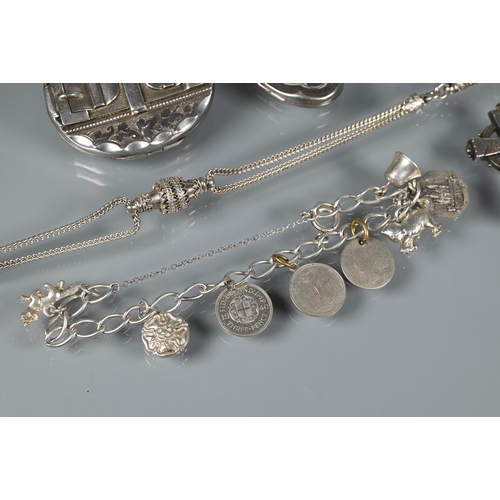 226 - A white metal curb bracelet with eight charms attached, a sterling chatelaine, silver locket now a b... 