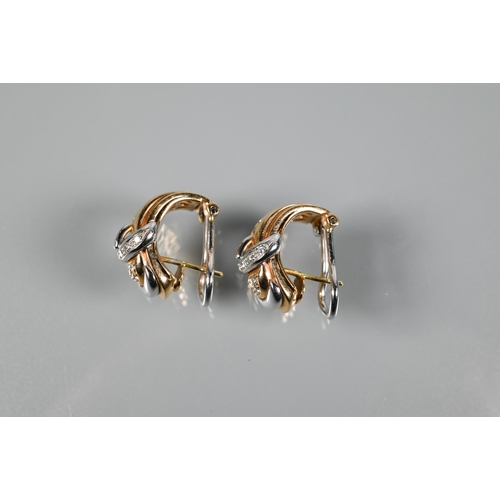 235 - A pair of Italian diamond-set half-hoop earrings in the form of a buckle, yellow and white metal set... 