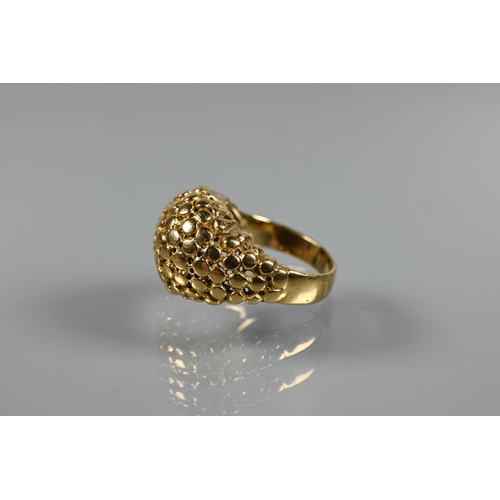 237 - A contemporary bombé ring of textured from, yellow metal stamped 750, size M, approx 7.5g